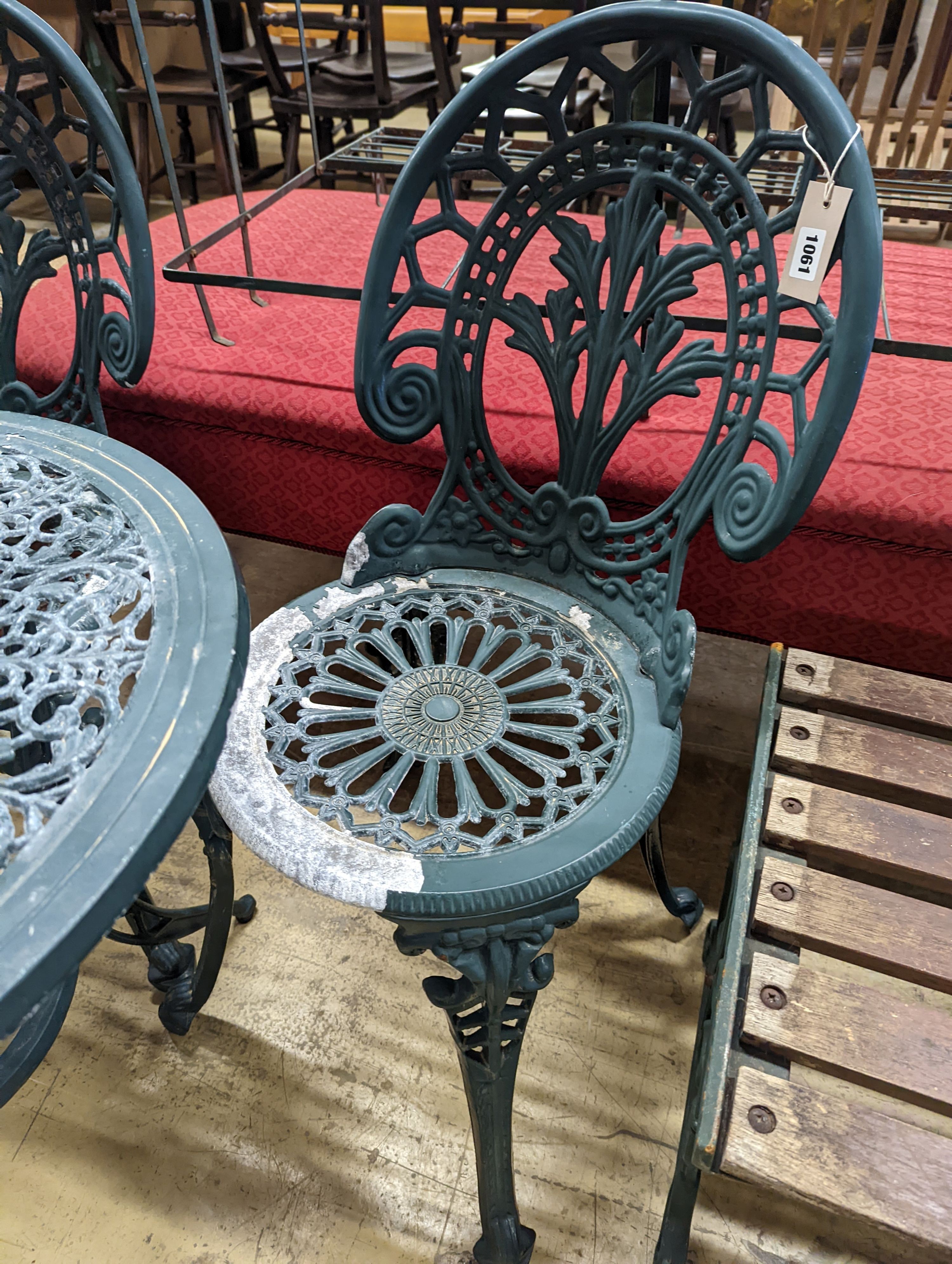 A circular painted aluminium garden table, diameter 60cm, height 62cm together with two chairs